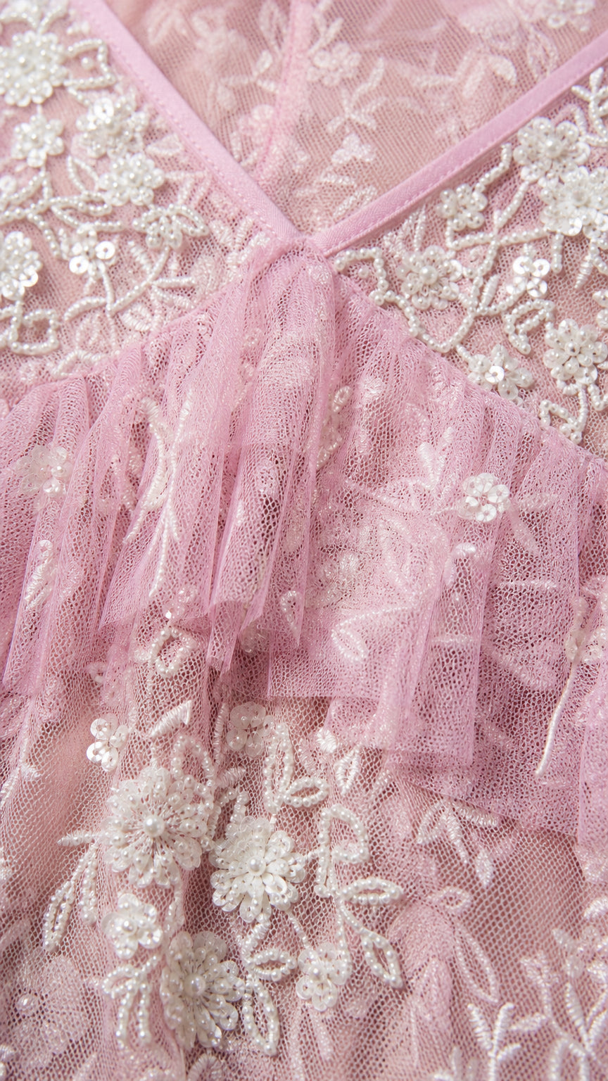 Close-up detail of V-neckline, sequins, and embroidery