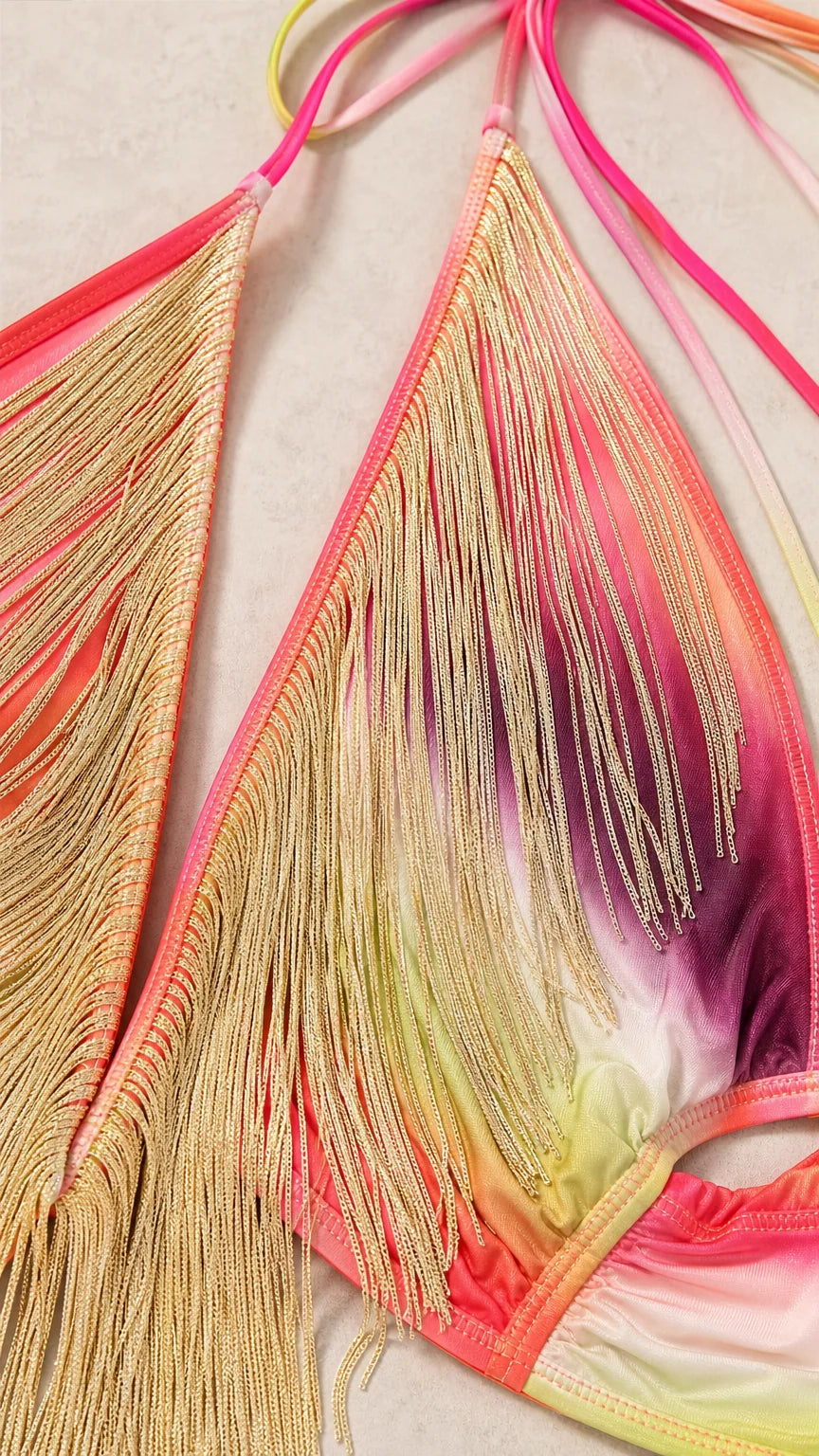 Close-up of metallic gold fringe and gradient fabric detail
