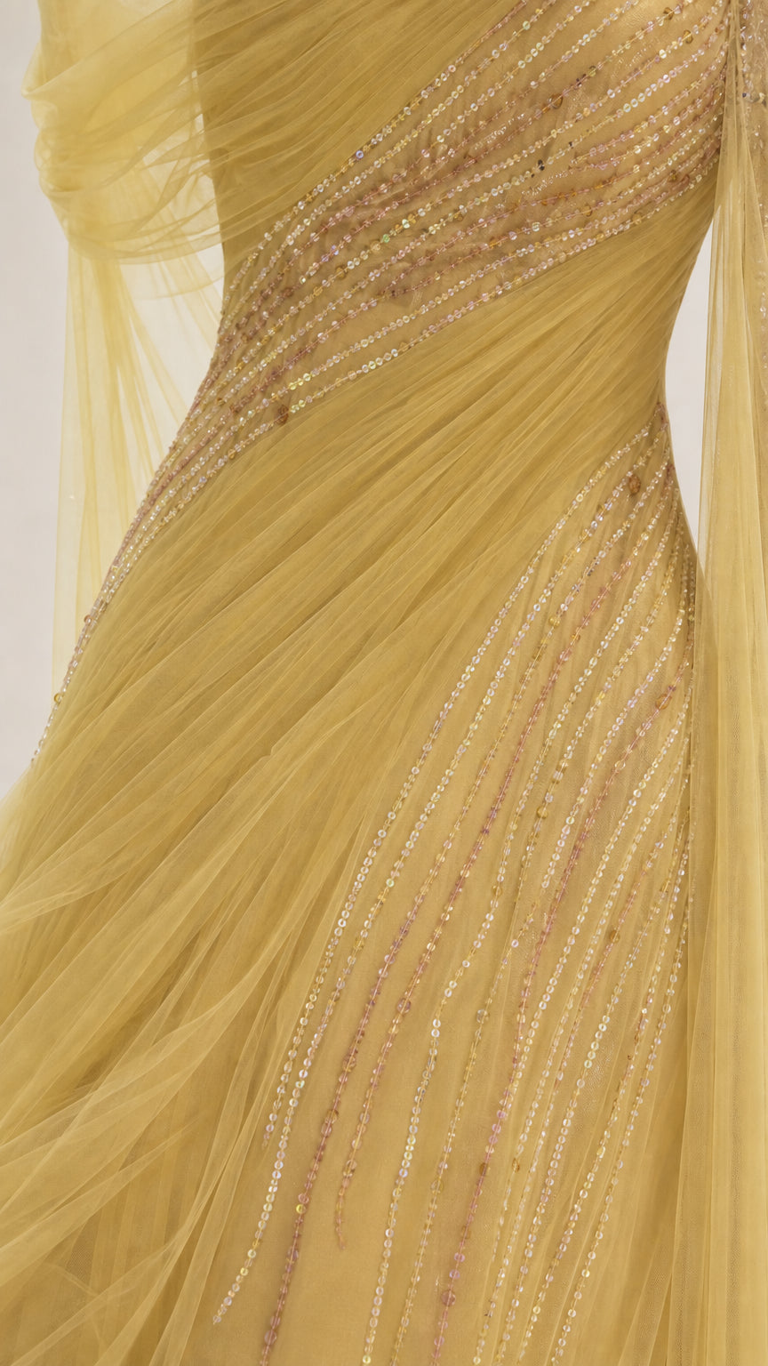 Close-up detail of sequin and bead embellishments on yellow dress