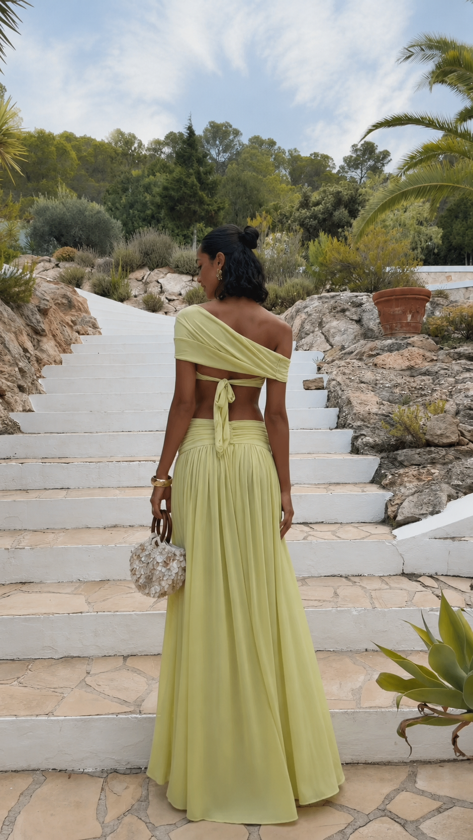 Back view of pistachio two piece maxi skirt set with tie-back off-shoulder top