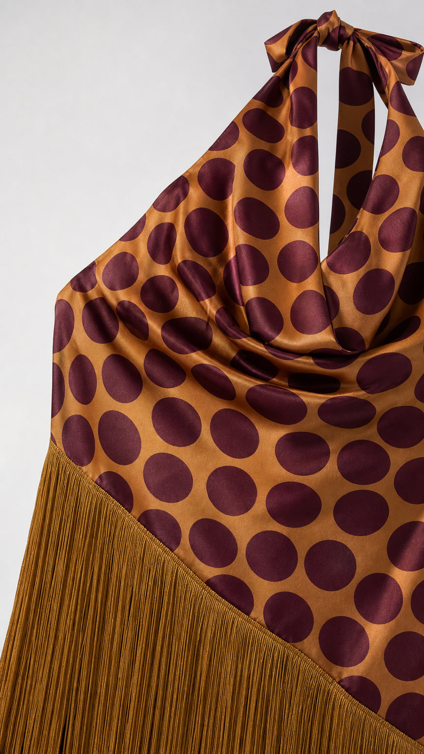 Close-up detail of halter neck tie, polka dot pattern, and fringe hem