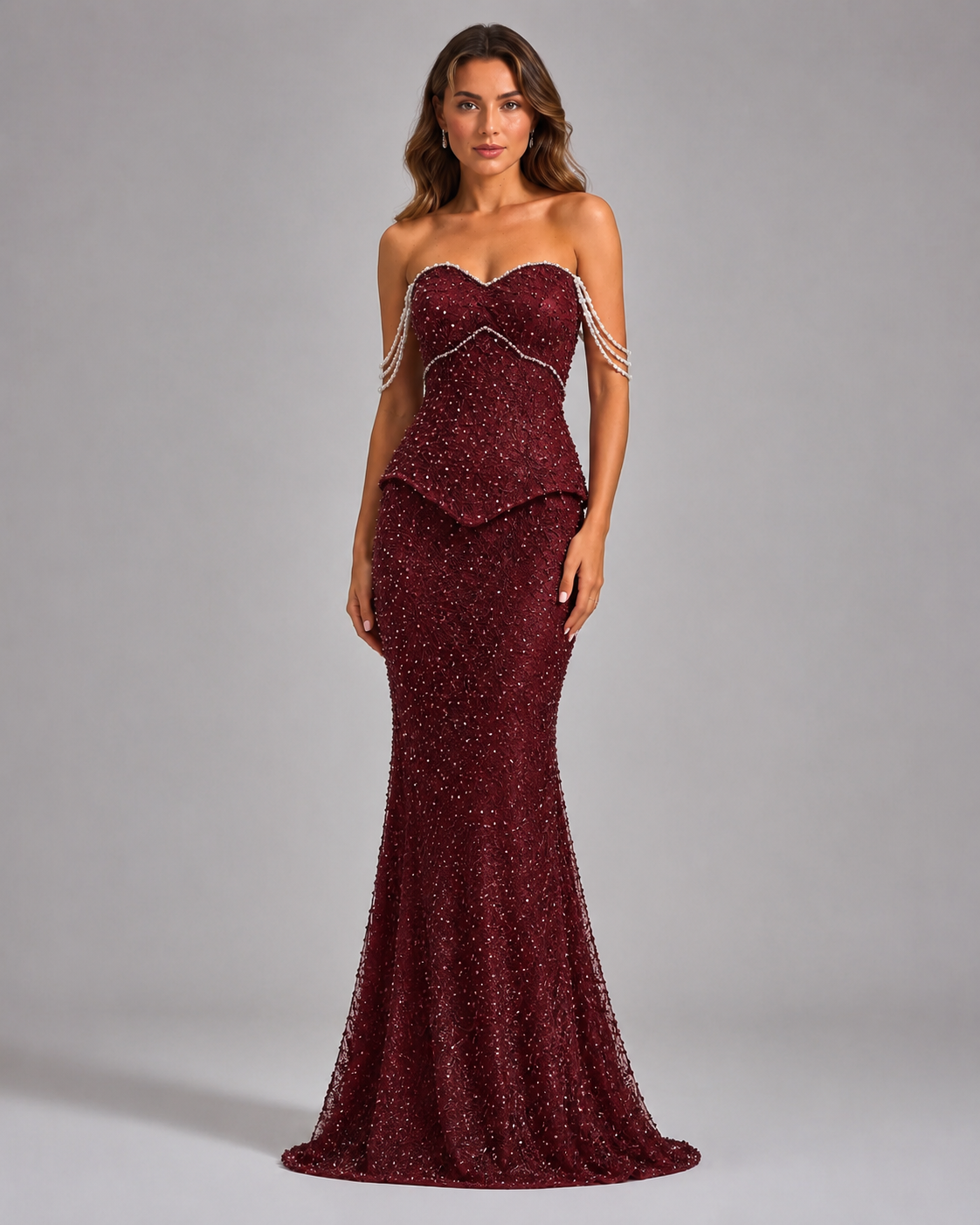Front view of burgundy embellished strapless formal mermaid dress