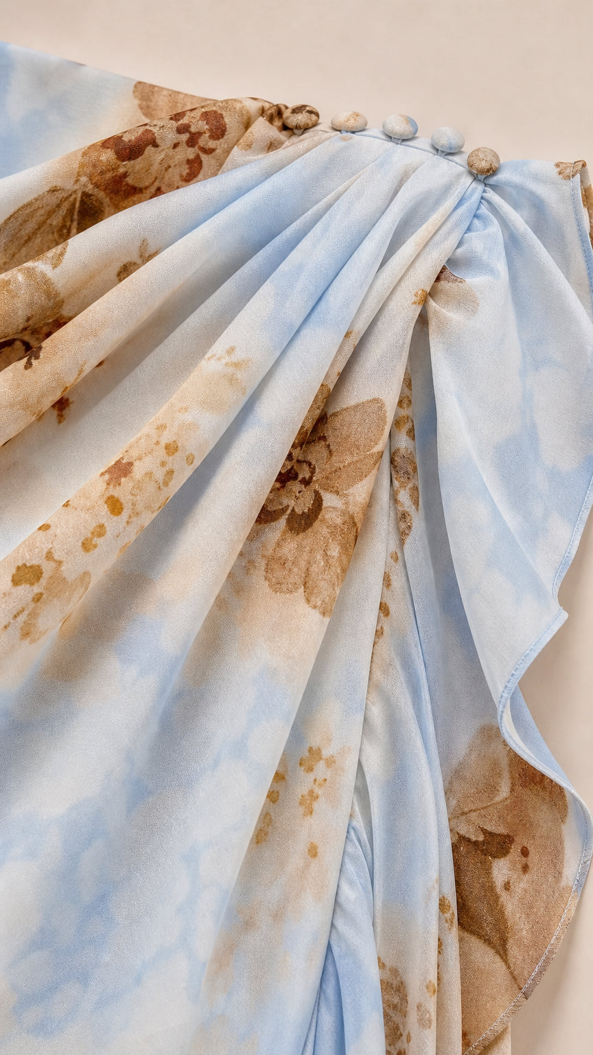 Close-up of shoulder button closure and ruffled fabric texture in Light Blue