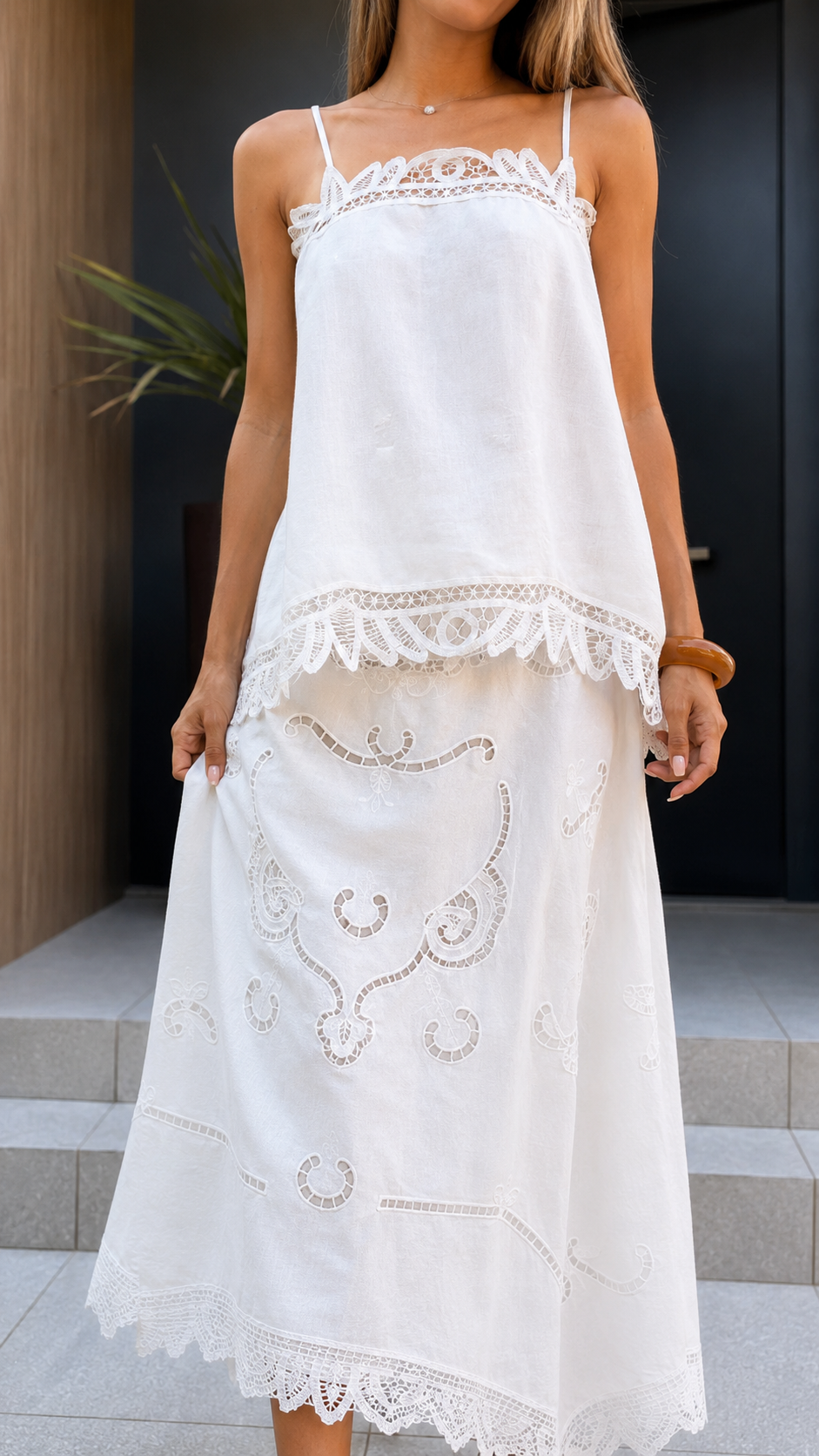 Close-up front detail of white cami top and midi skirt showing lace trim and hem accents