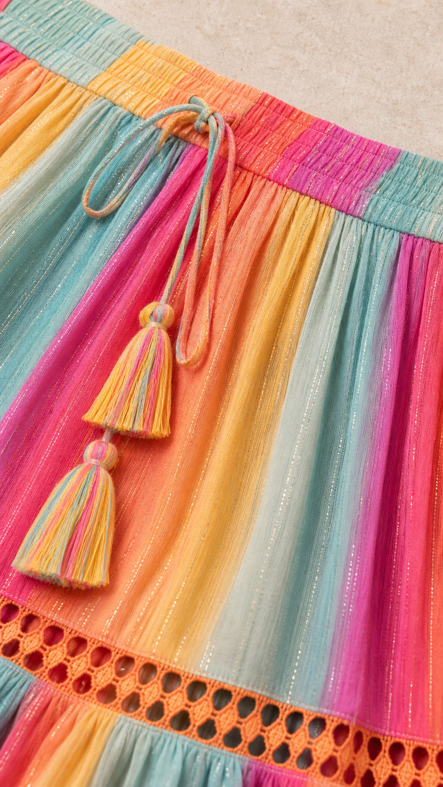 Close-up of waistband and tassel detail on multi-color striped maxi skirt