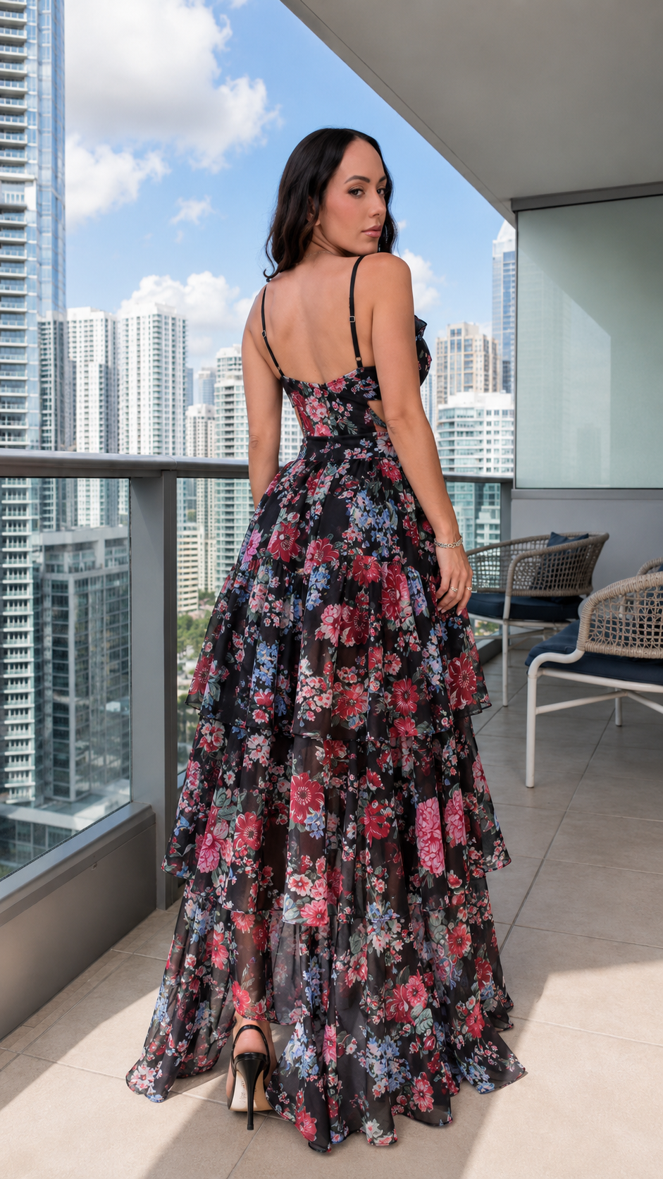 Back view of black floral strappy maxi dress with open back and cascading ruffles