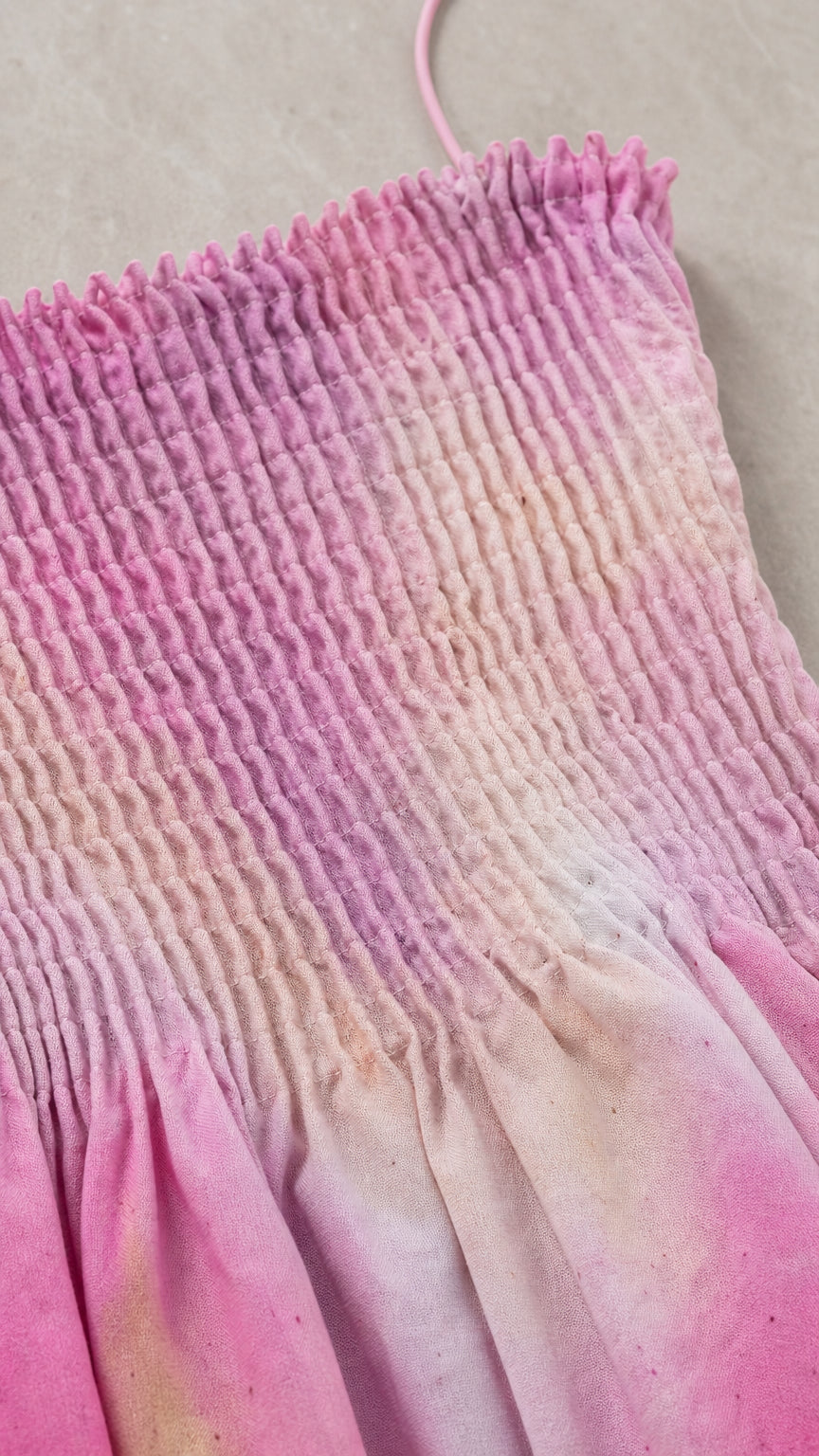 Close-up detail of smocked bodice and tie-dye fabric texture