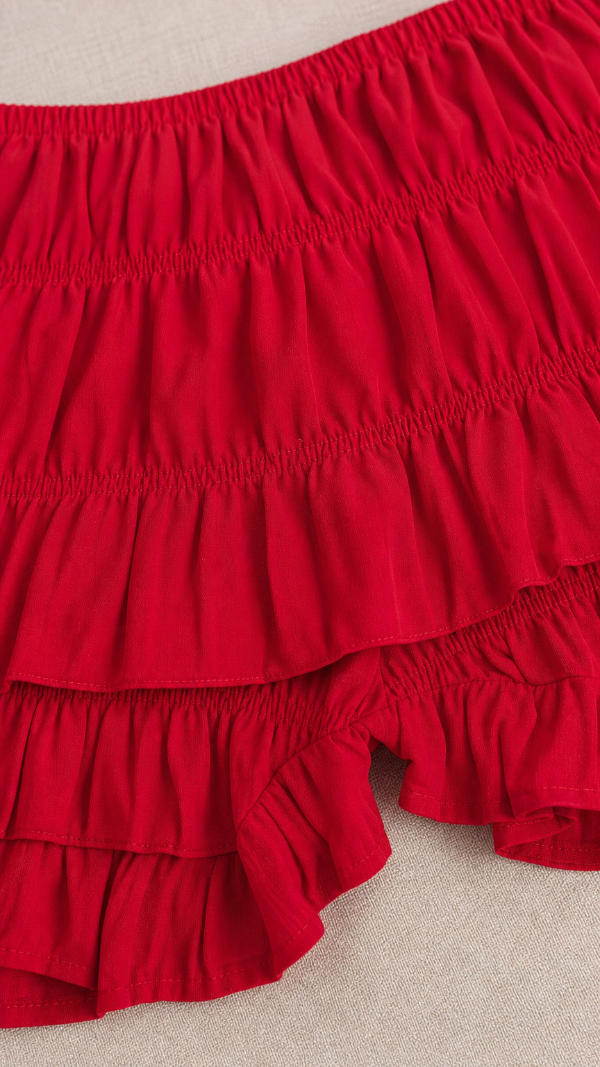Close-up of the red crinkled fabric and layered ruffle shorts