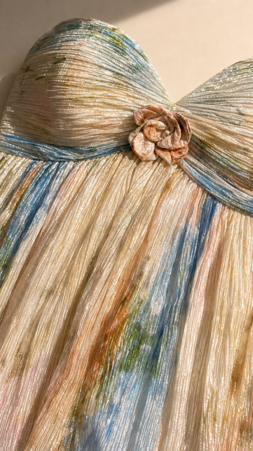 Close up of textured pleating and floral applique on strapless dress