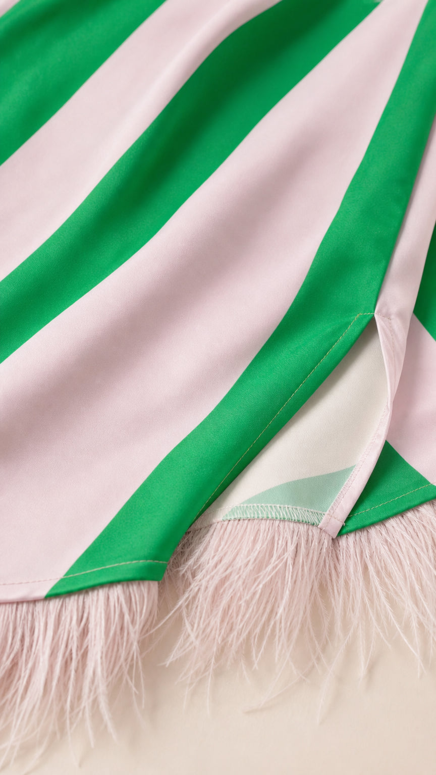 Close-up of green diagonal stripe fabric and feather hem detail
