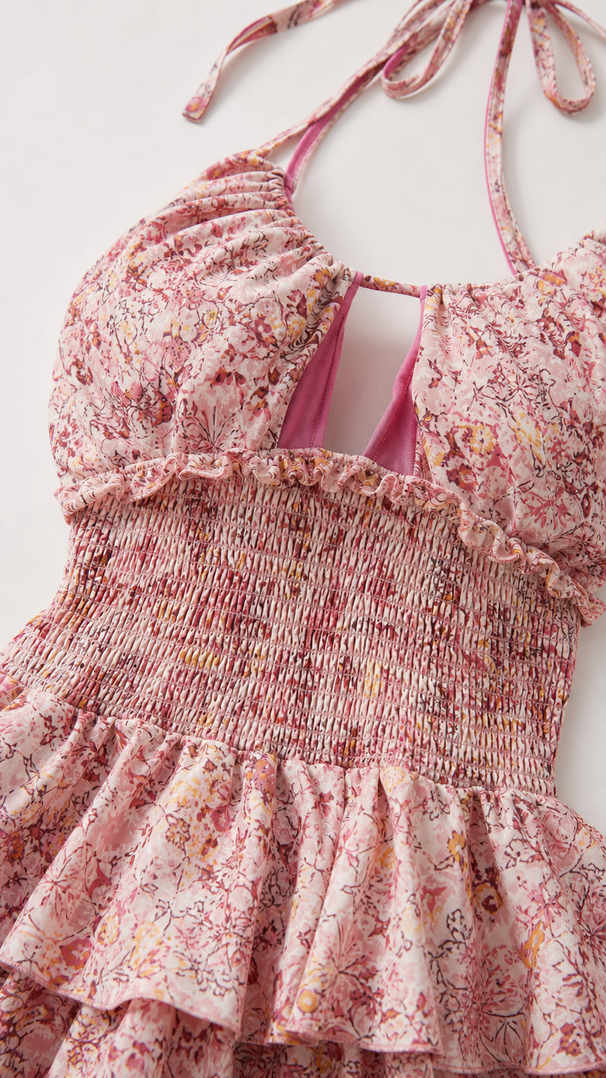 Close-up detail of bodice and tiered skirt on pink floral dress