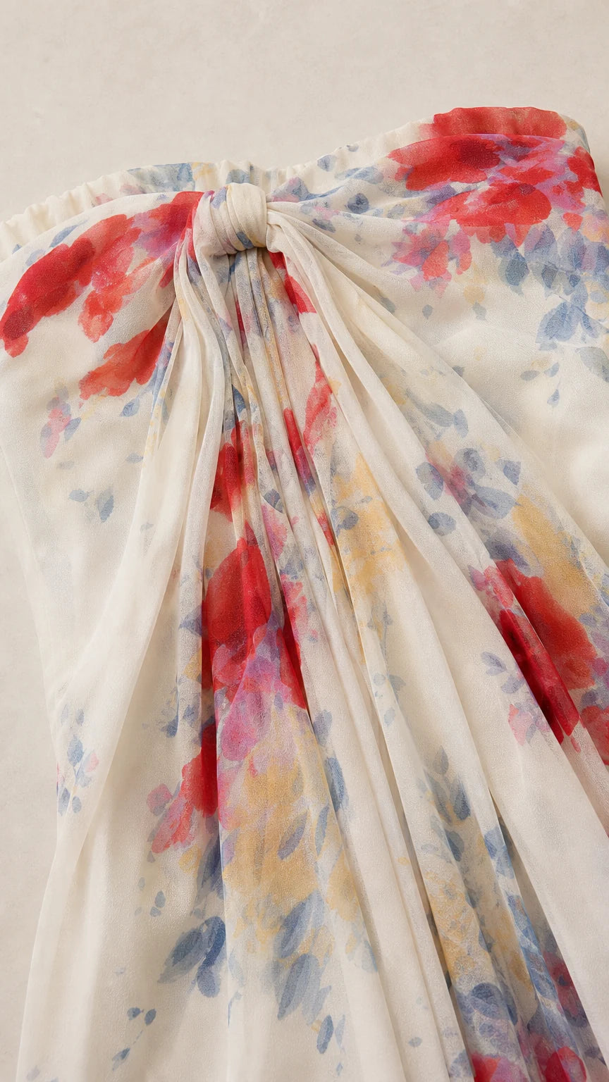 Close-up detail of the gathered front bow and floral pattern