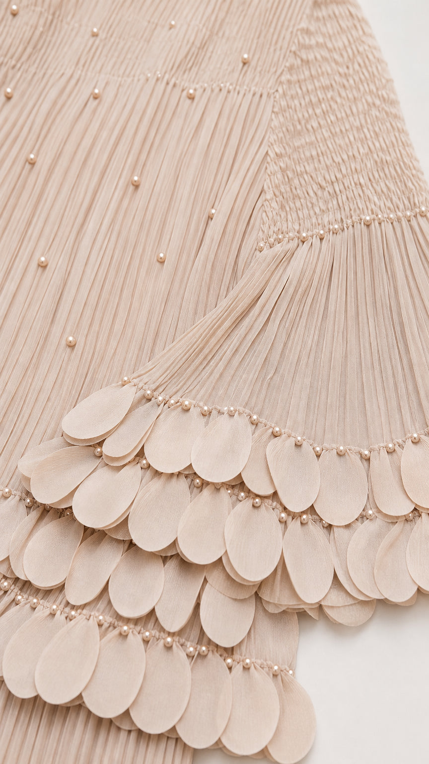 Close-up of pearl embellishments and scalloped sleeve hem