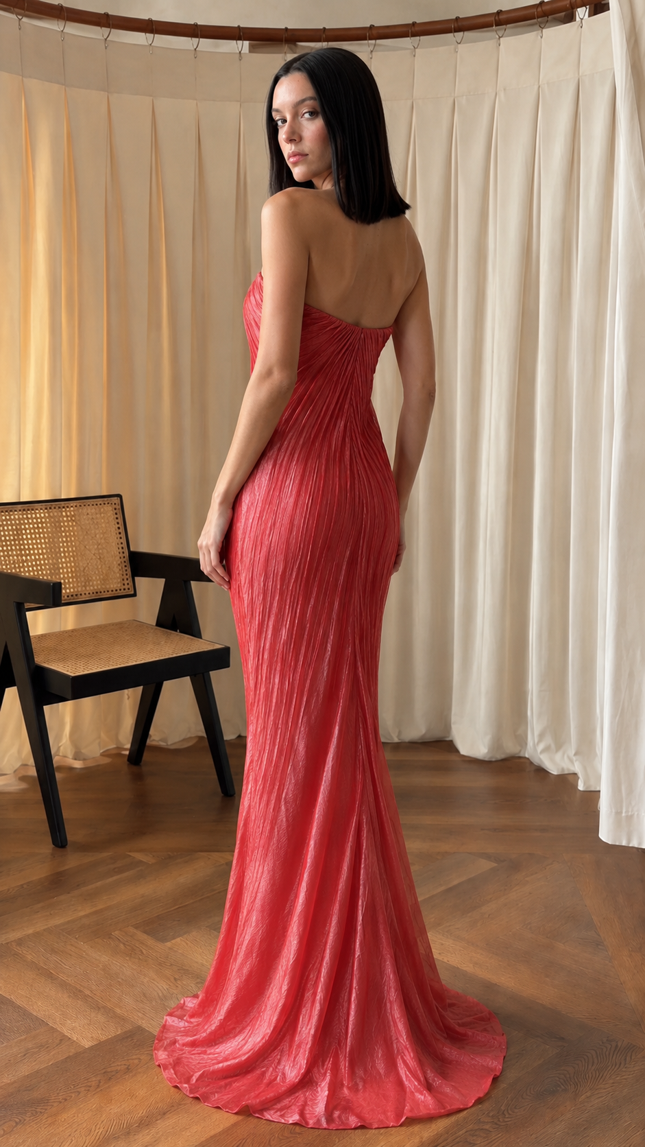 Back view of rose red strapless pleated fitted maxi gown