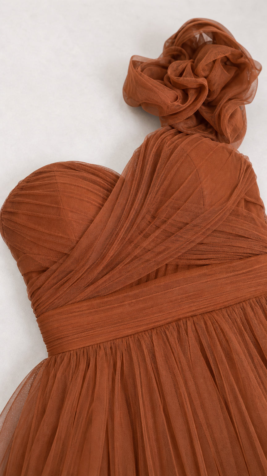 Close-up of ruched bodice and shoulder flower applique