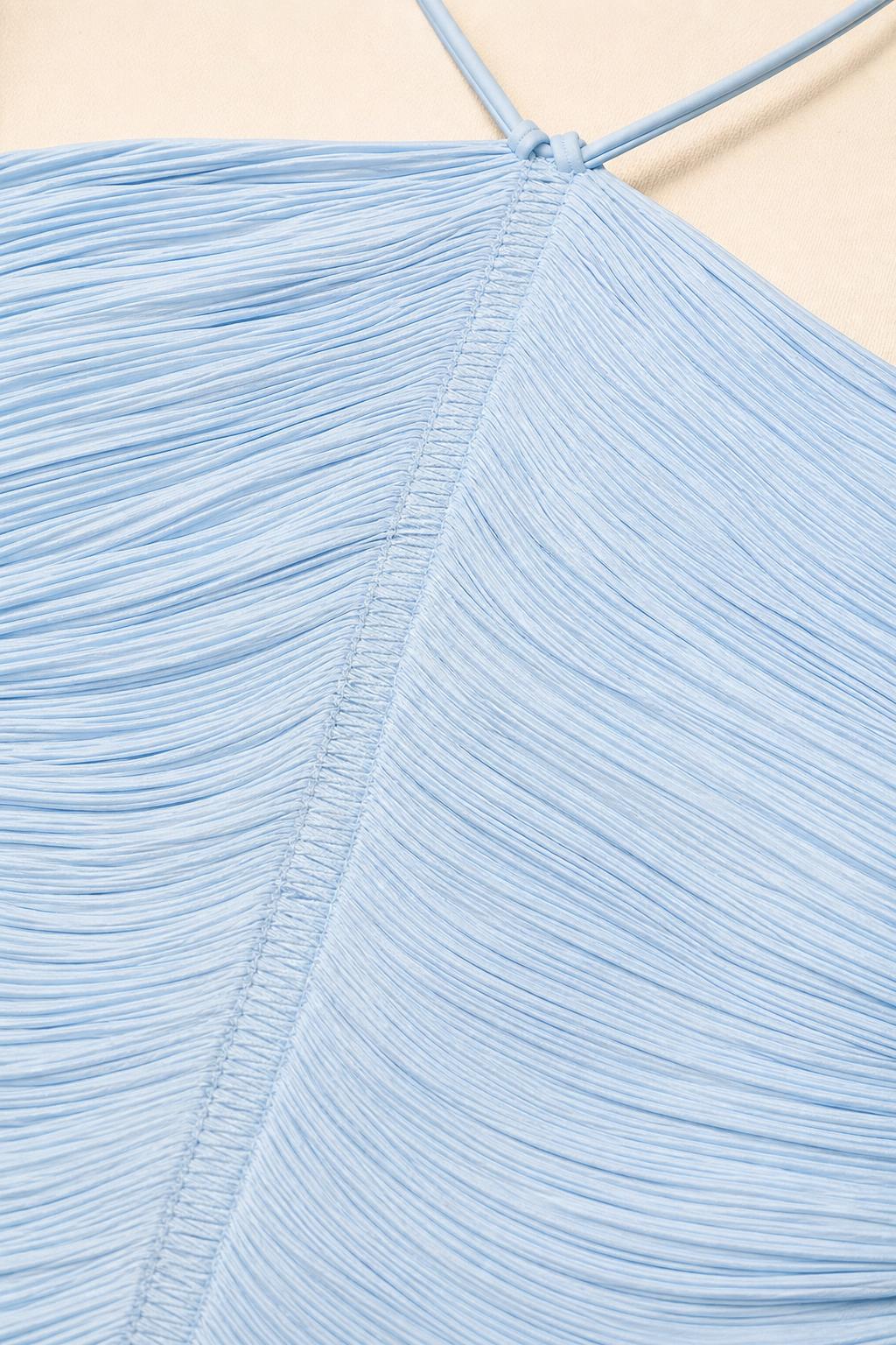 Close-up of light blue textured ruched fabric and neckline construction