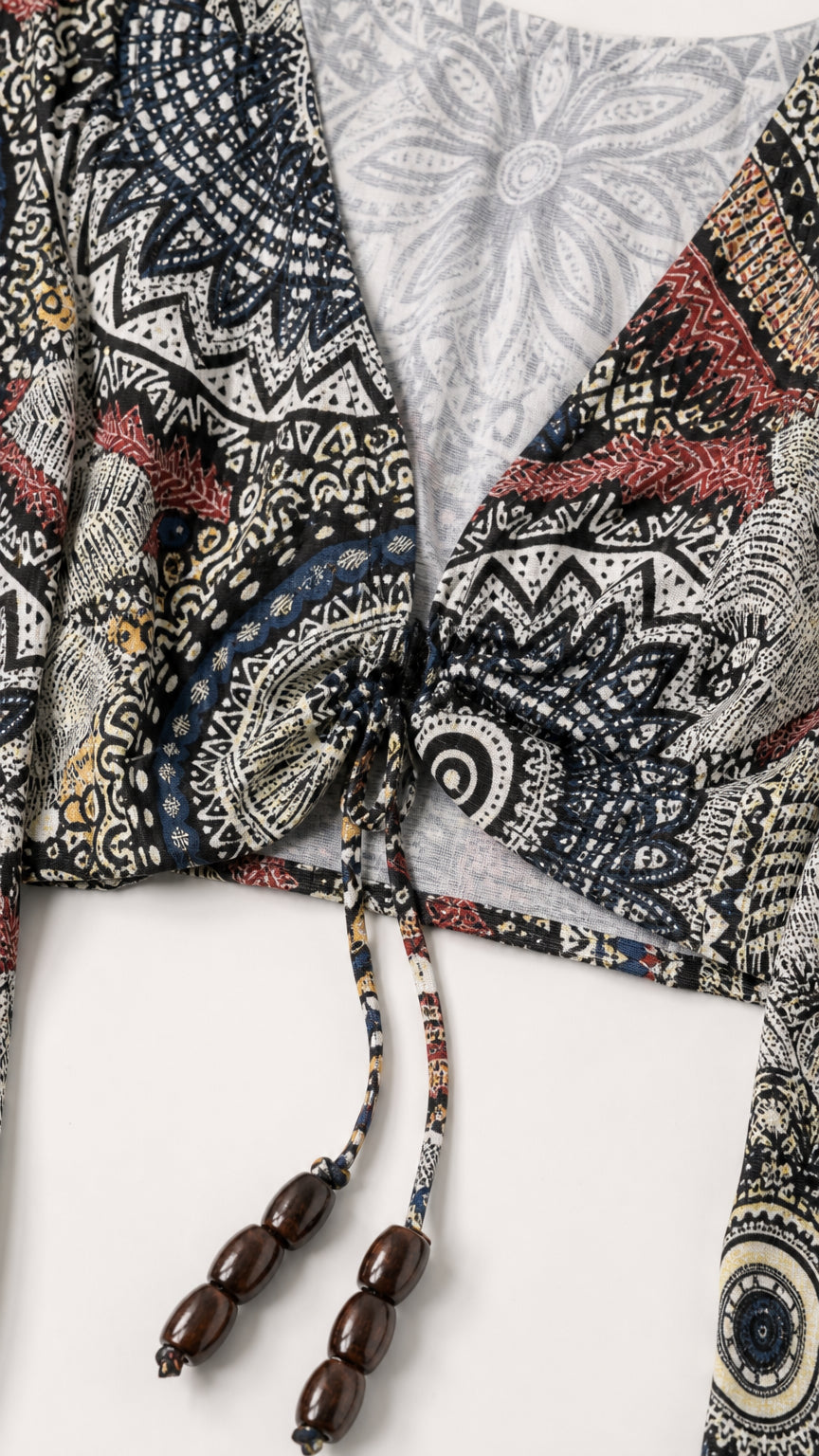 Close-up detail of the tie-front V-neck crop top with beaded tassels