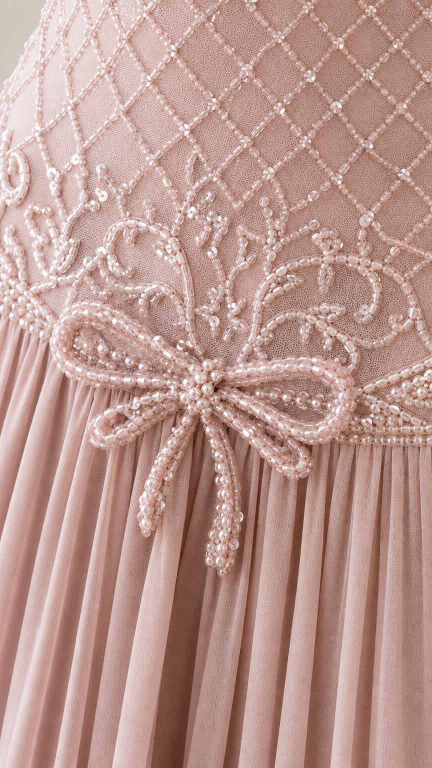 Close-up detail of intricate beadwork and waist bow on bodice
