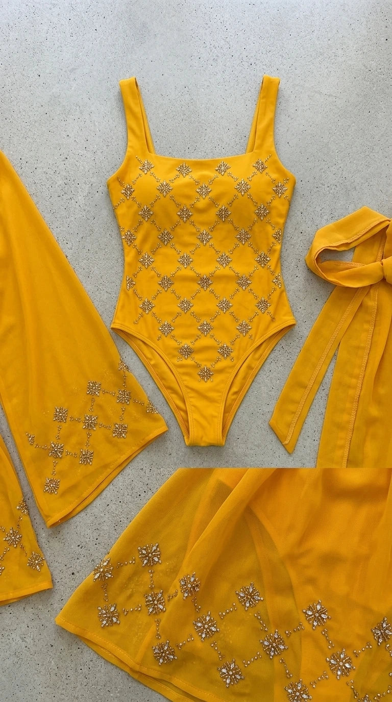 Flat lay of yellow embellished bodysuit, kimono sleeves, and tie belt