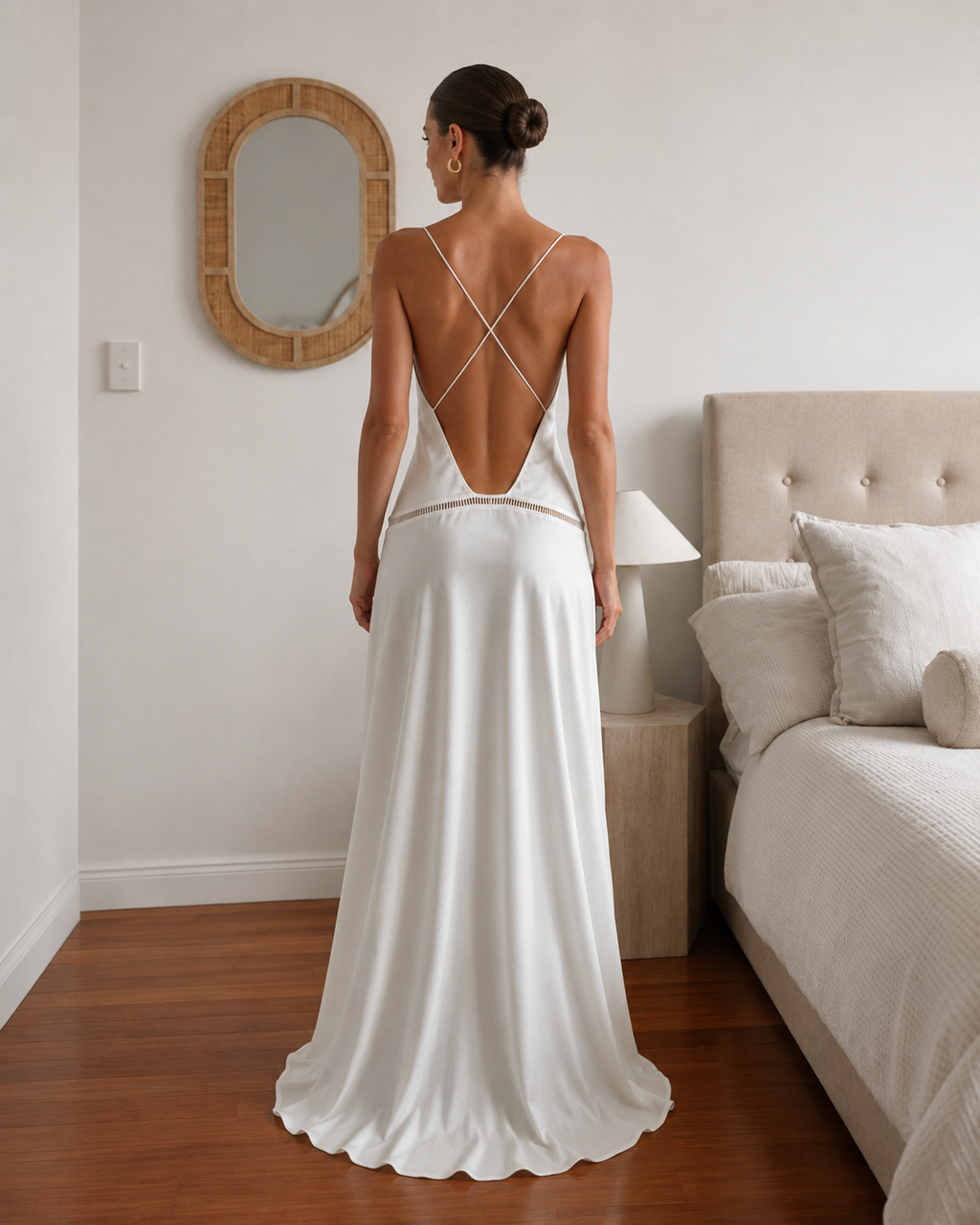 Back view of ivory satin-style maxi dress with open back and crisscross straps