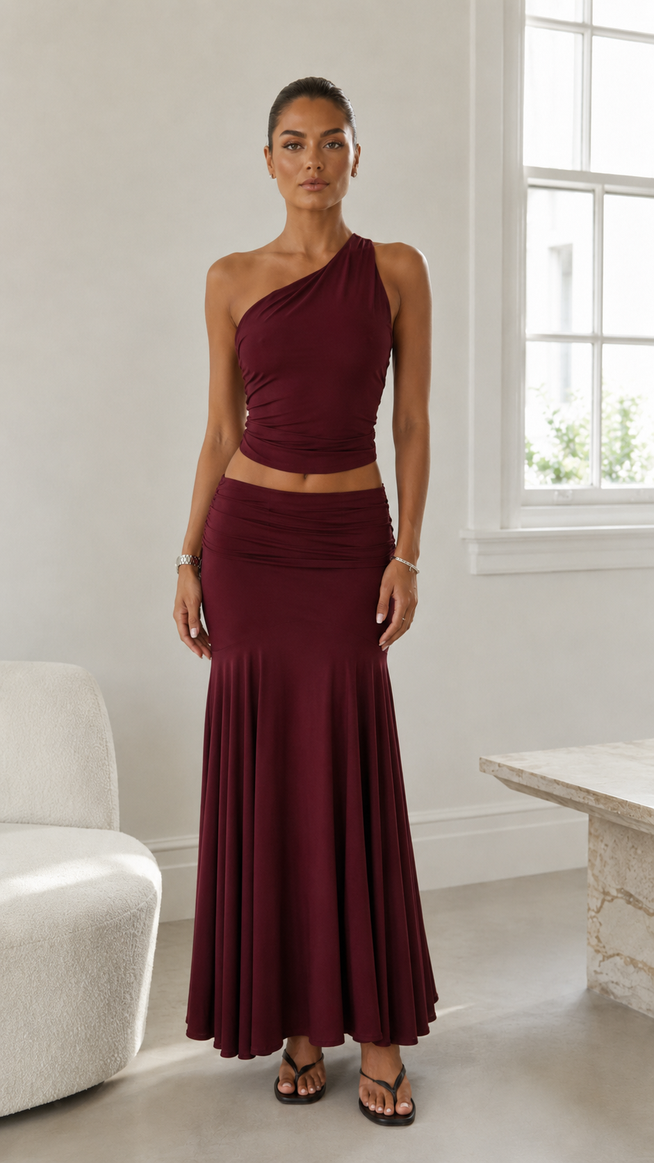 Front view of burgundy one-shoulder ruched two-piece skirt set