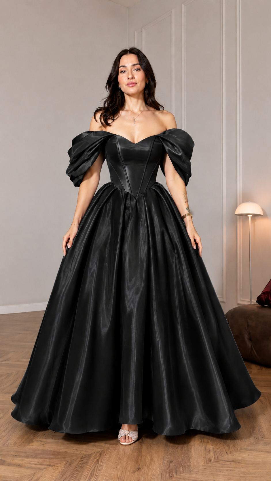 Front view of black off shoulder ball gown with structured bodice and full skirt
