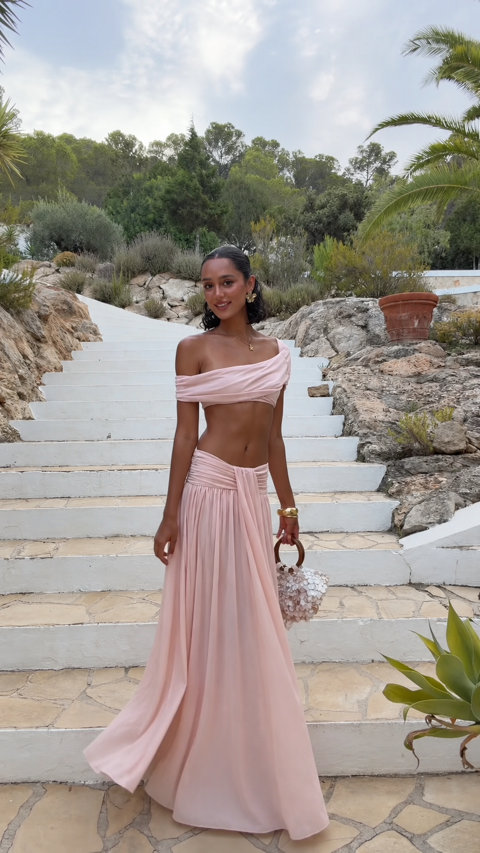 Blush pink off-shoulder crop top and flowing maxi skirt matching set front view