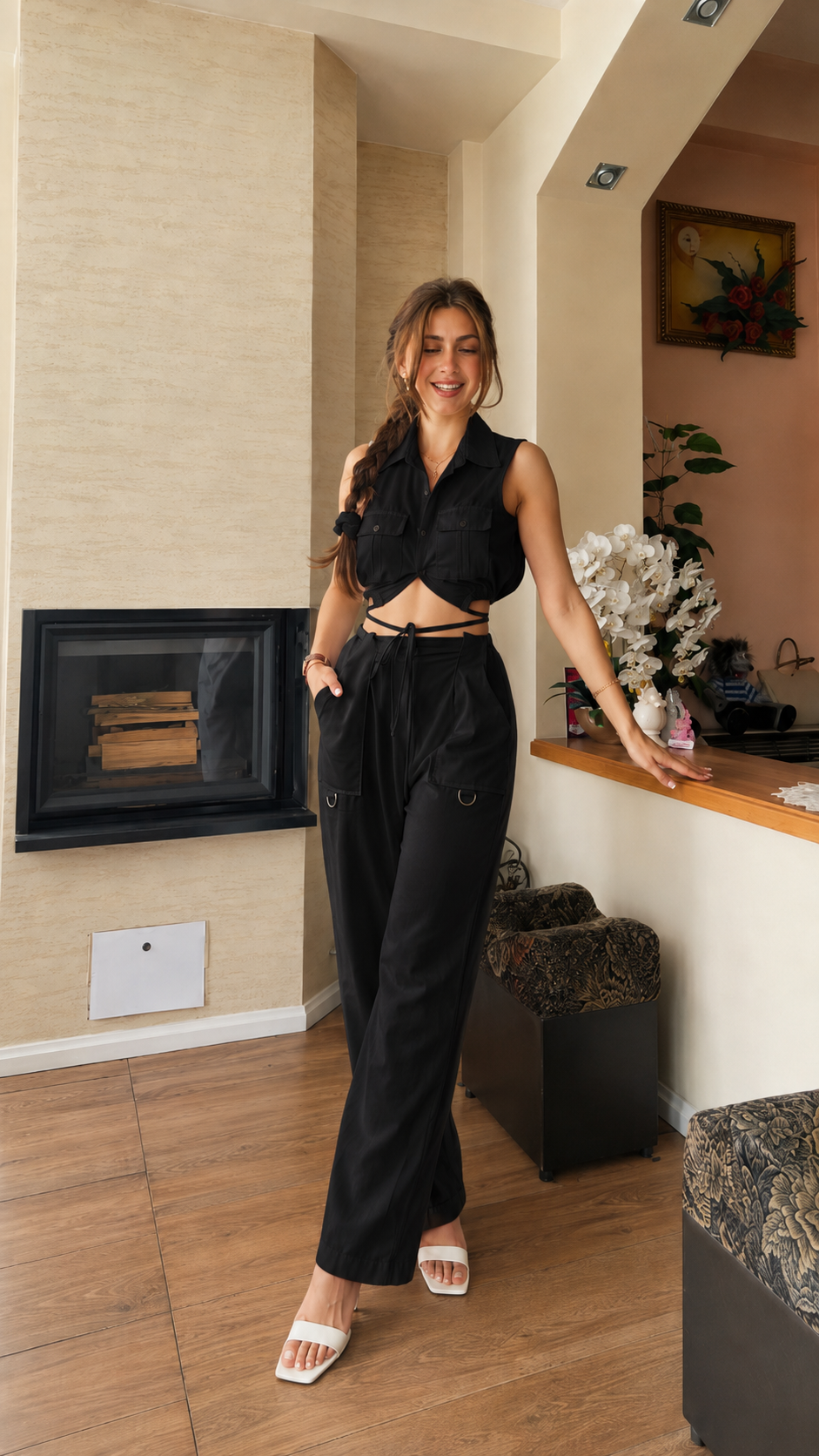 Front view of black sleeveless tie front crop top and wide leg pants matching set