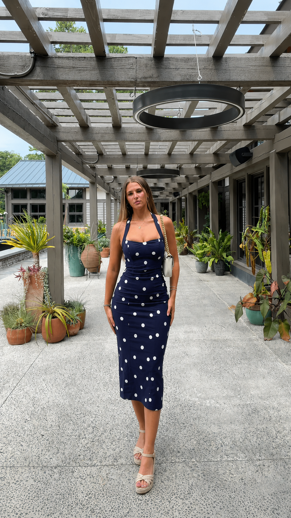 Front view of navy polka dot bodycon midi dress with square neck