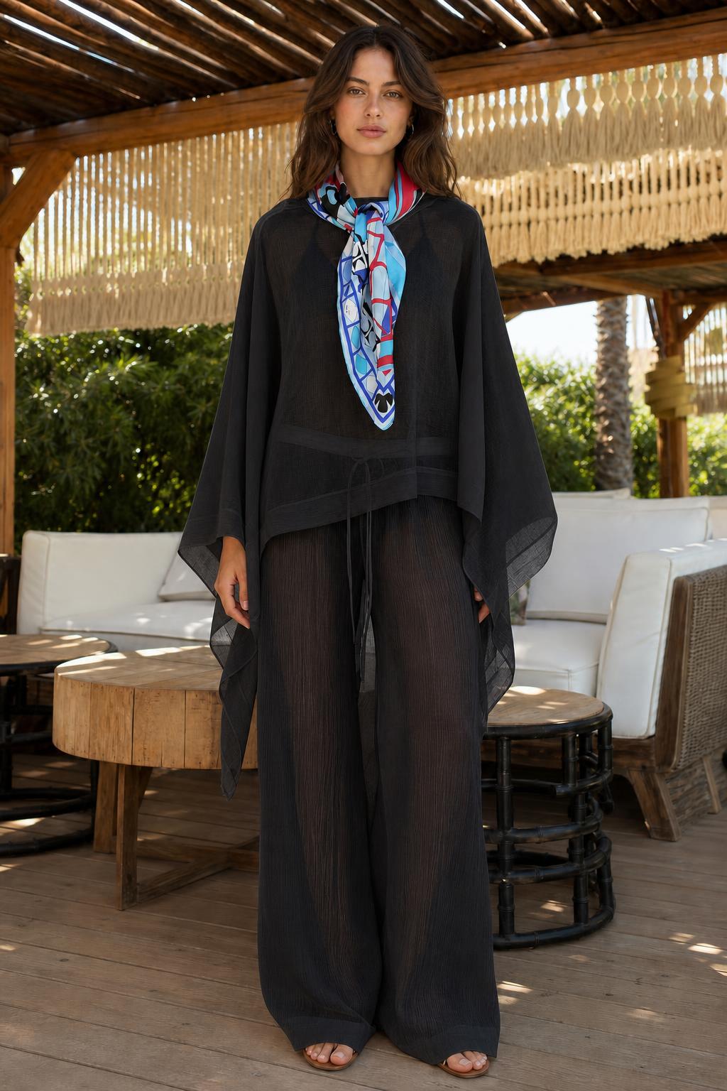 Model wearing black two-piece kaftan and wide-leg pants set