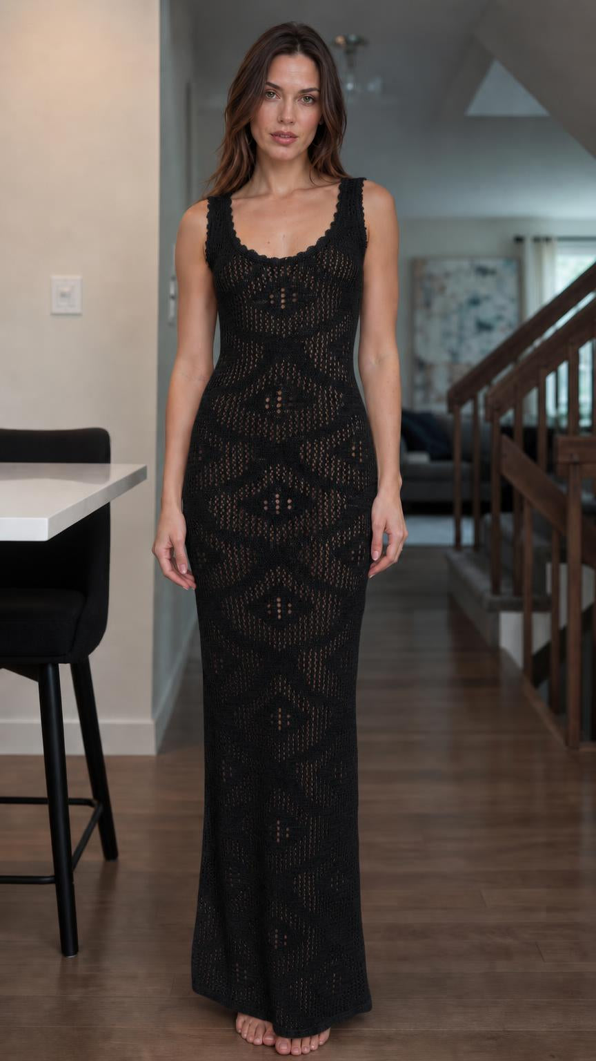 Front view of woman wearing black open knit maxi dress