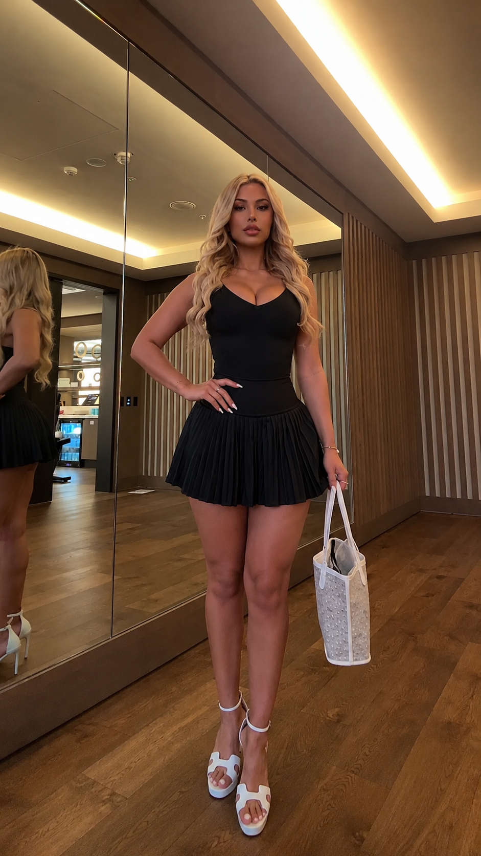Front view of black pleated fit and flare mini dress