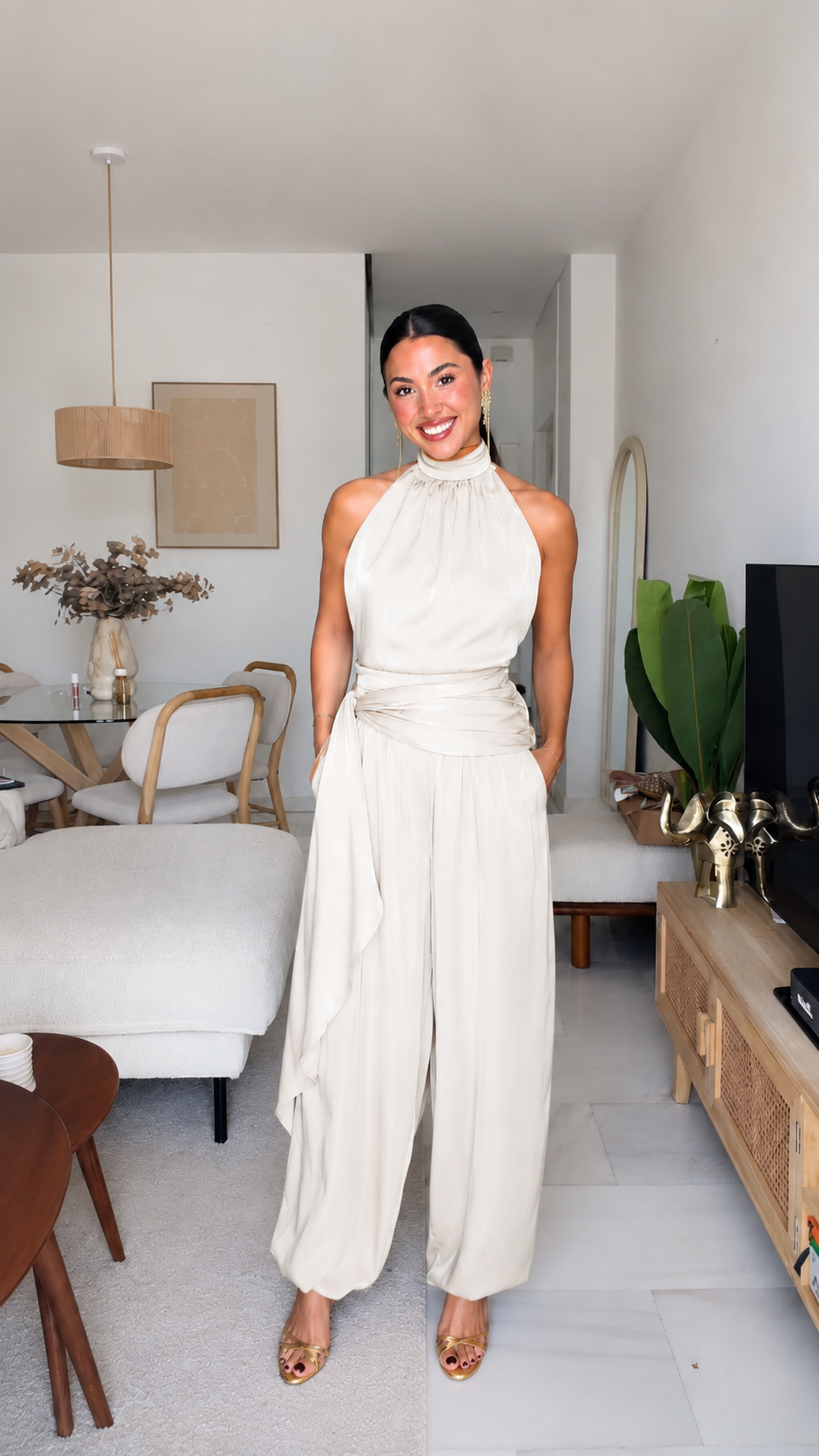 Ivory halter neck jumpsuit with draped waist and relaxed wide-leg silhouette
