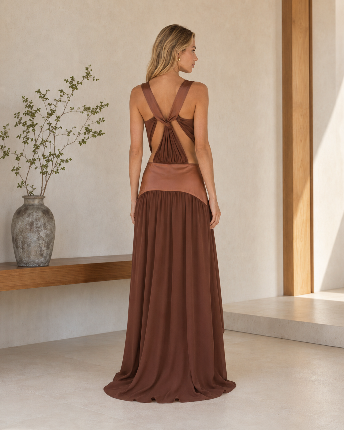 Back view of chocolate brown maxi dress with open twisted back detail