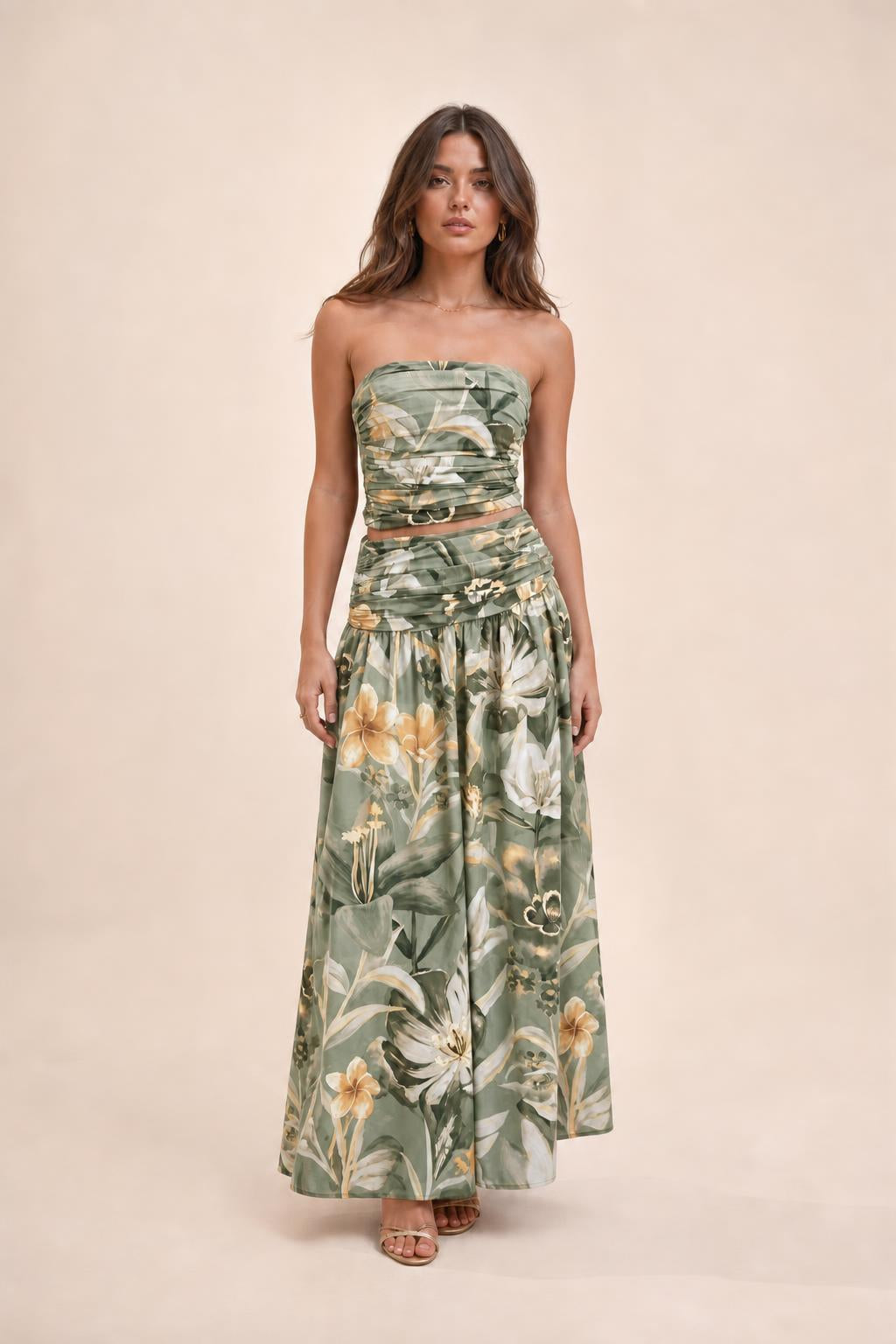 Model wearing green floral strapless crop top and maxi skirt set