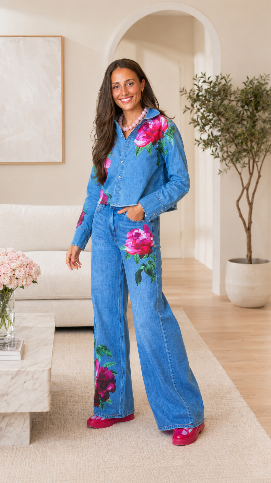 Front angled view of light blue floral print denim jacket and wide leg jeans set
