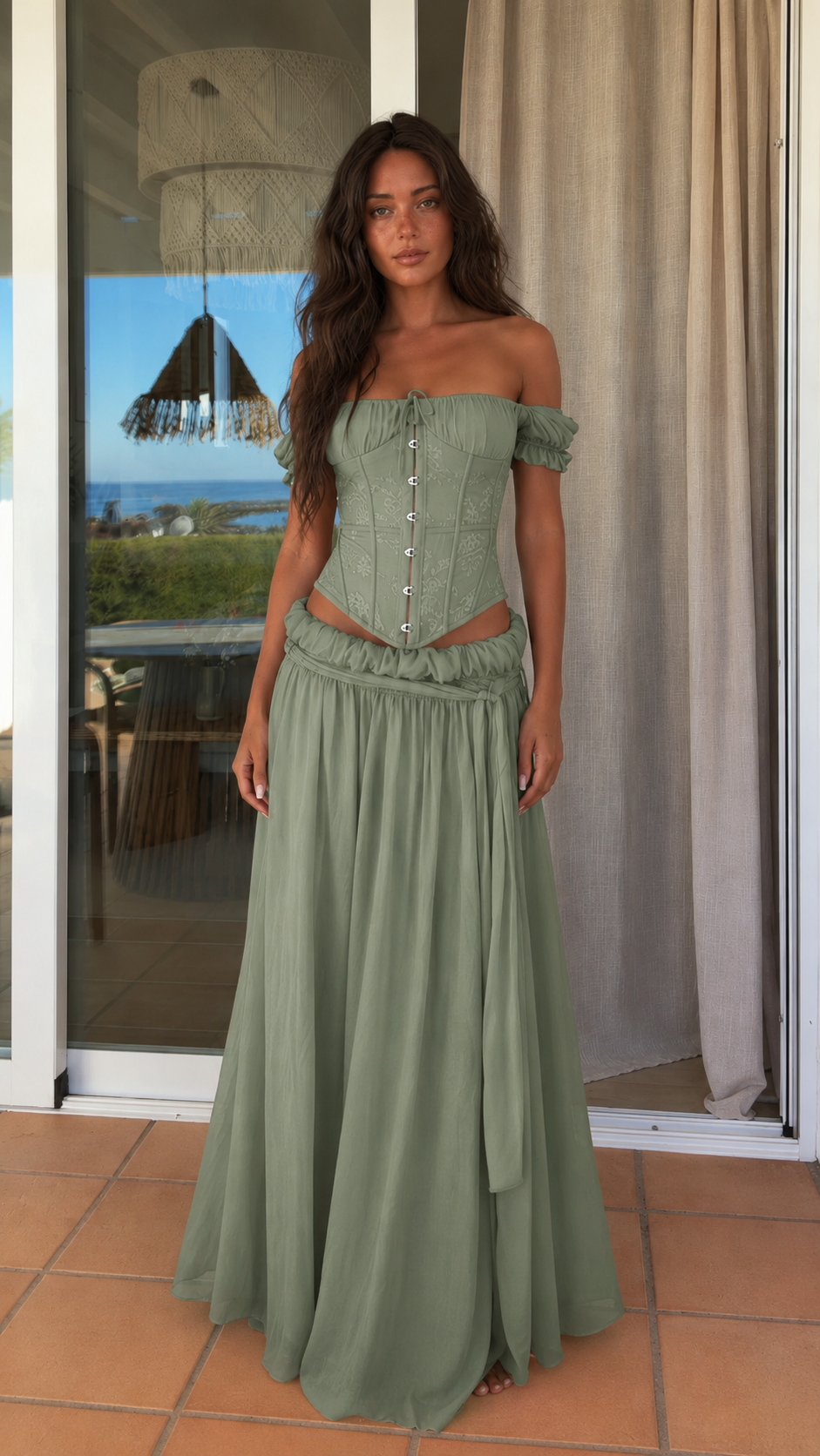 Front view of sage green off shoulder corset top and maxi skirt set