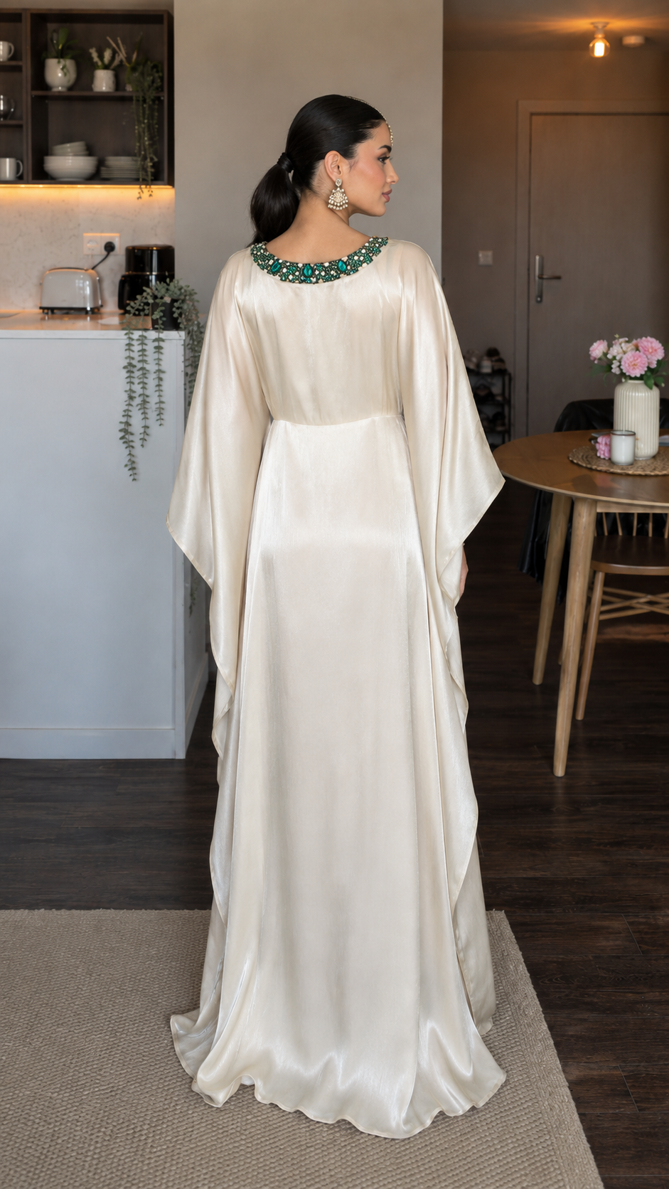 Back view of champagne satin-look maxi dress showing fluid drape and full-length hem