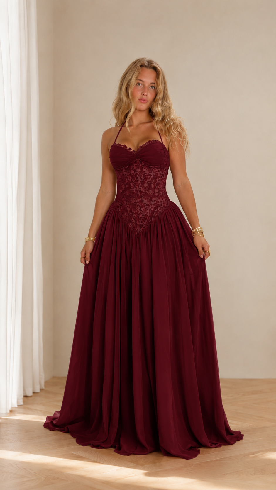 Front view of burgundy halter prom dress with lace bodice