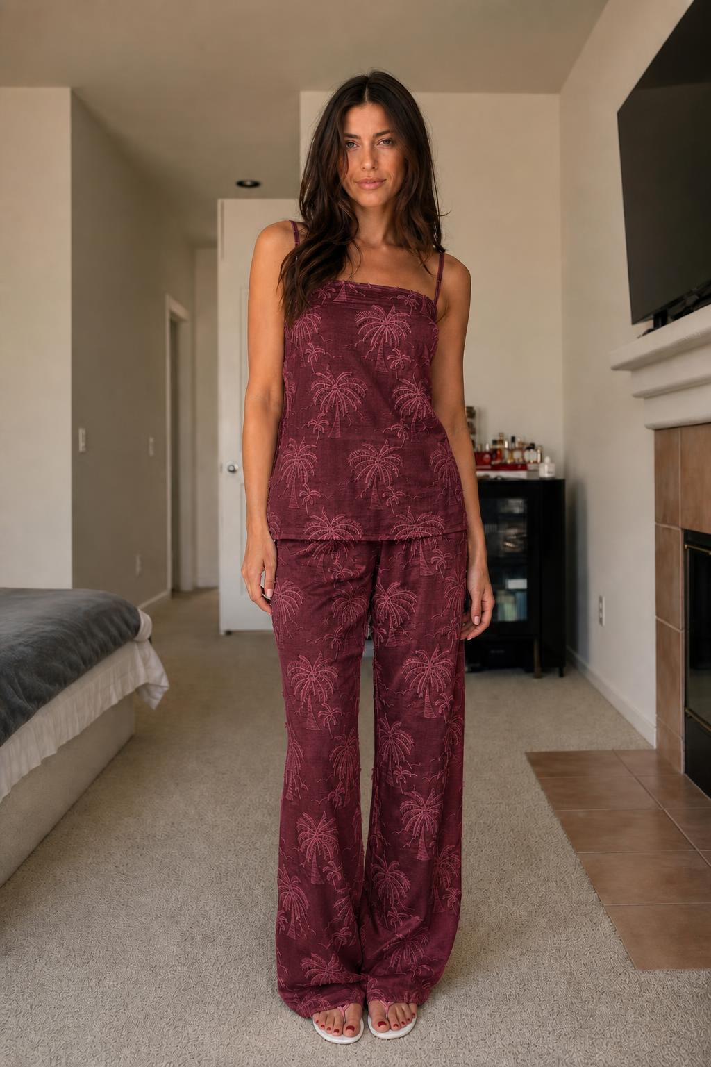 Front view of woman wearing burgundy palm embroidered two-piece set
