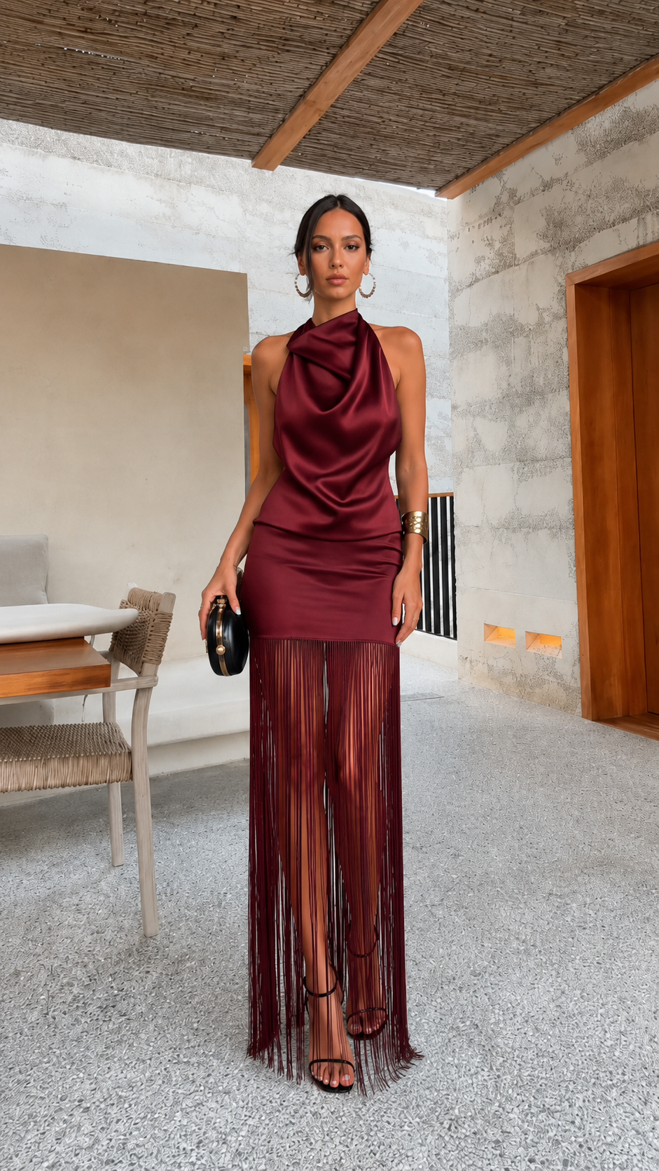 Burgundy satin-look halter maxi dress with draped neckline and flowing fringe