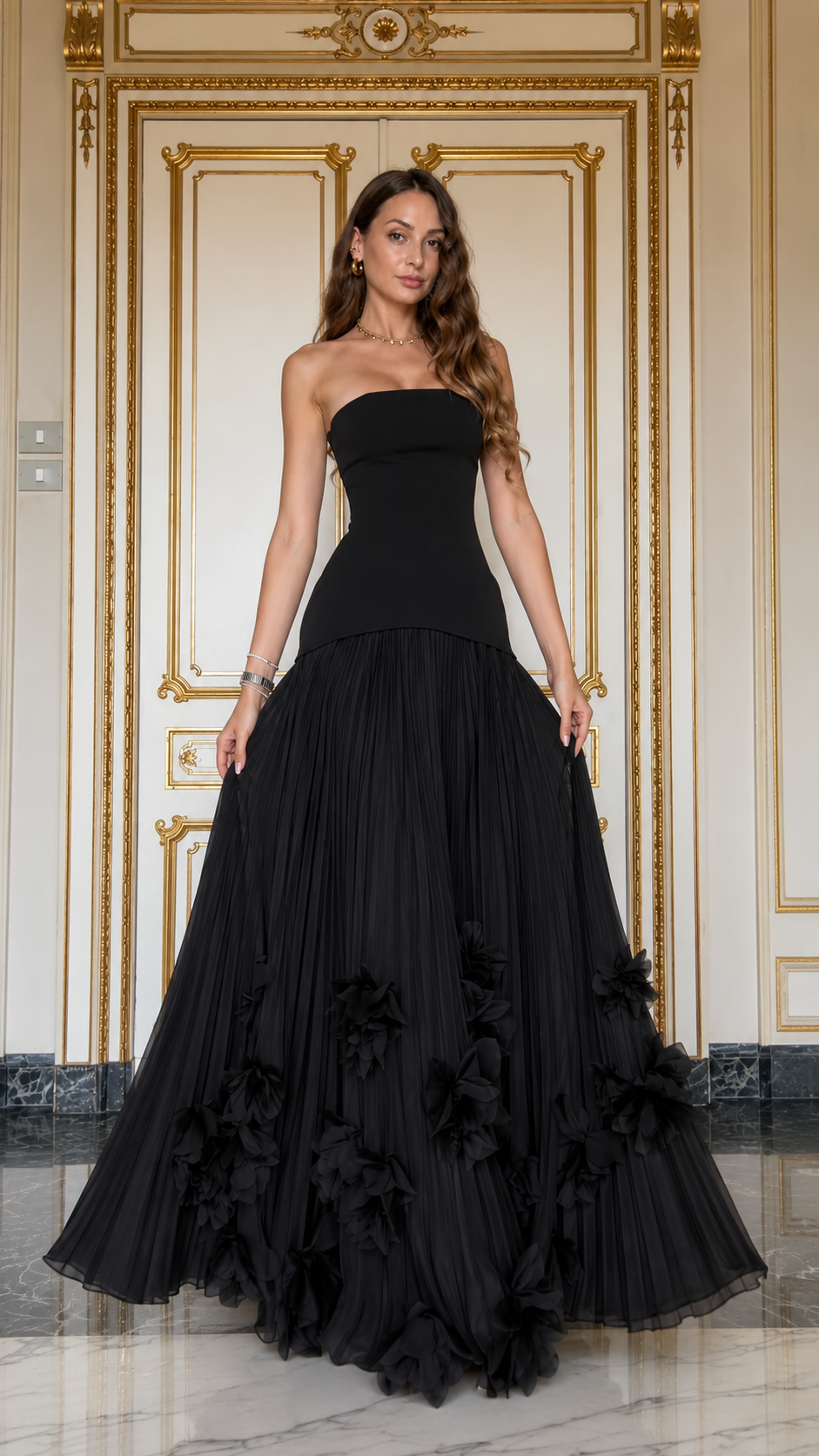 Front view of black strapless pleated maxi gown with full-length skirt