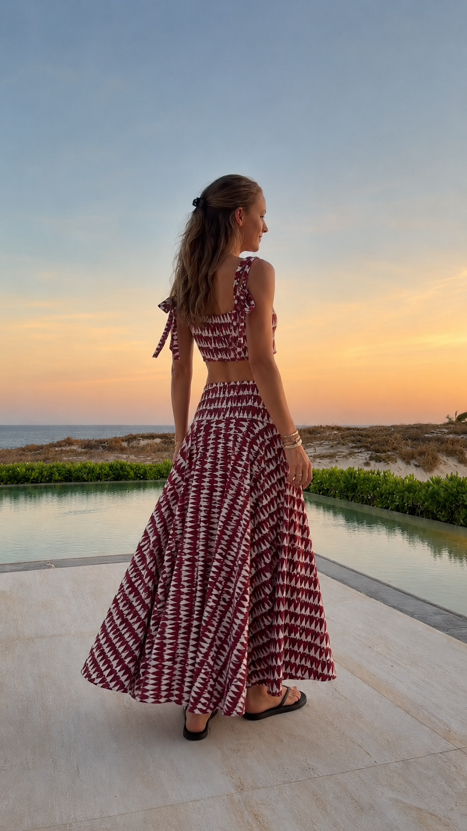 Back view of burgundy printed two-piece crop top and maxi skirt set