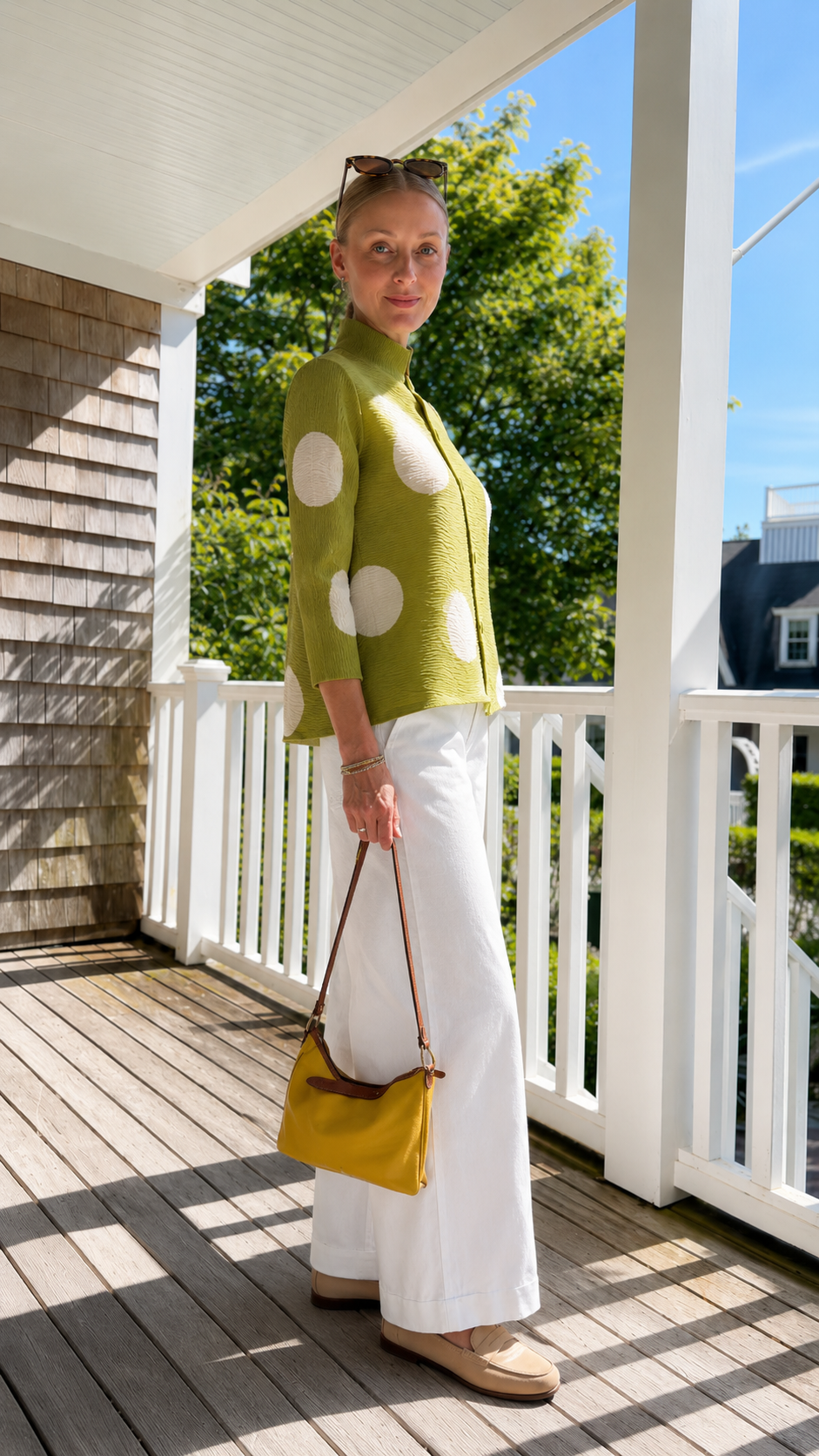 Side view of olive green pleated polka dot jacket top showing relaxed drape and hip length