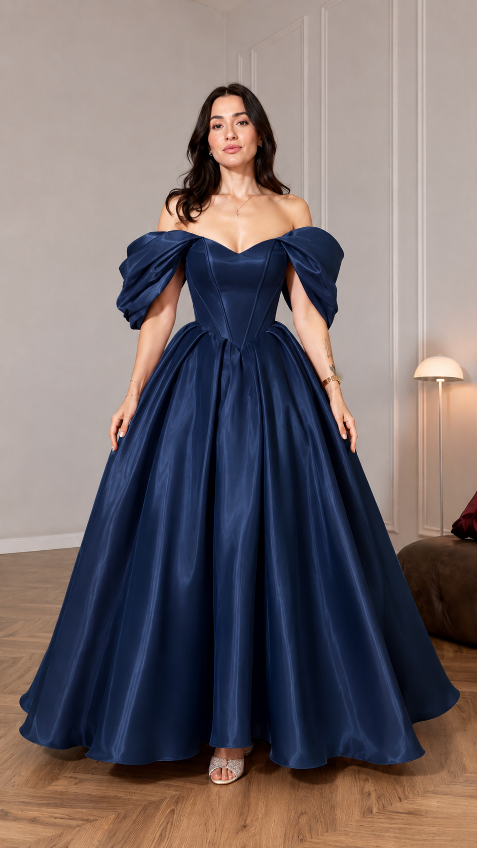 Front view of navy off shoulder ball gown with puff sleeves and floor-length silhouette