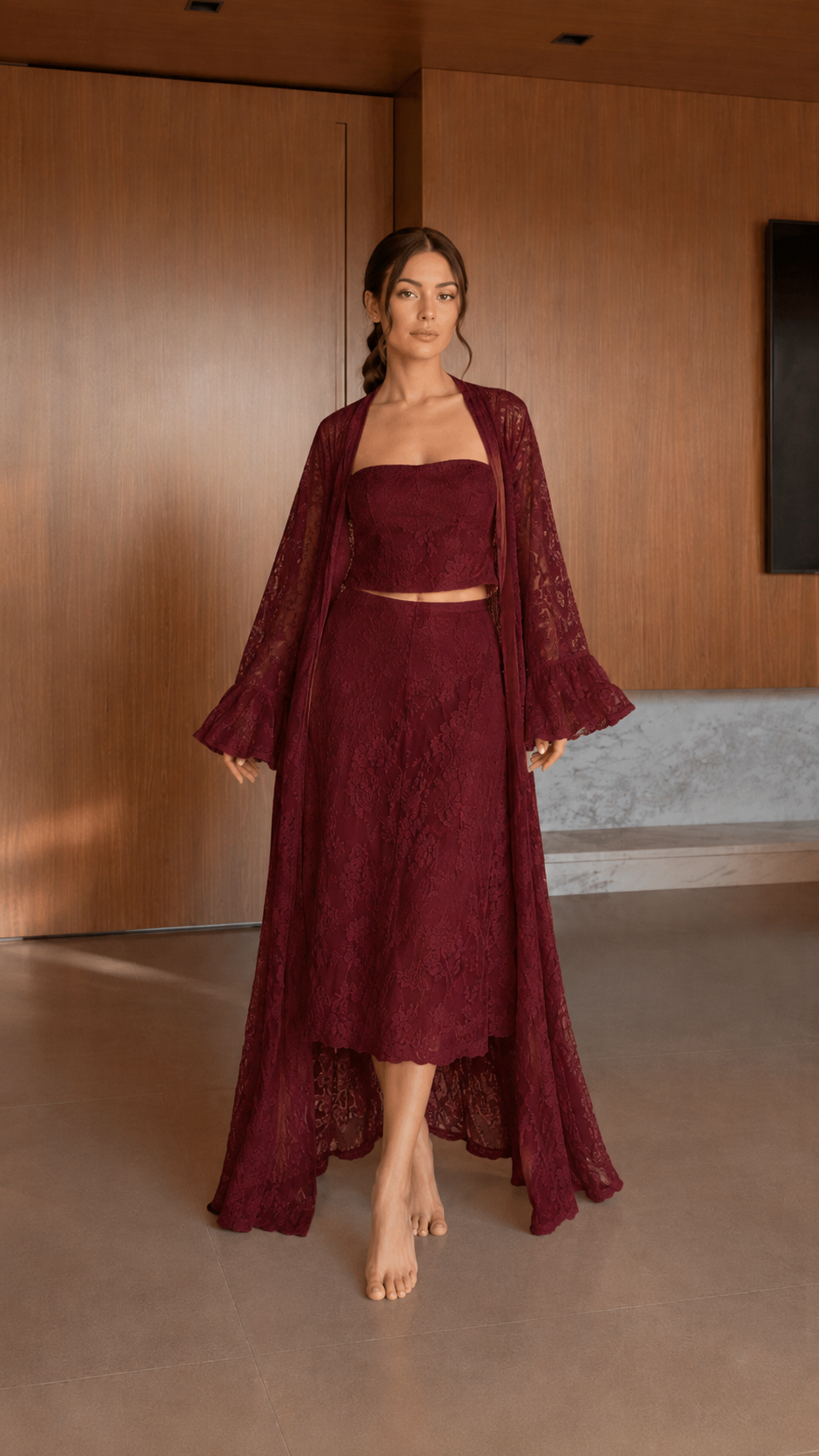 Front view of burgundy textured skirt set with dramatic long duster