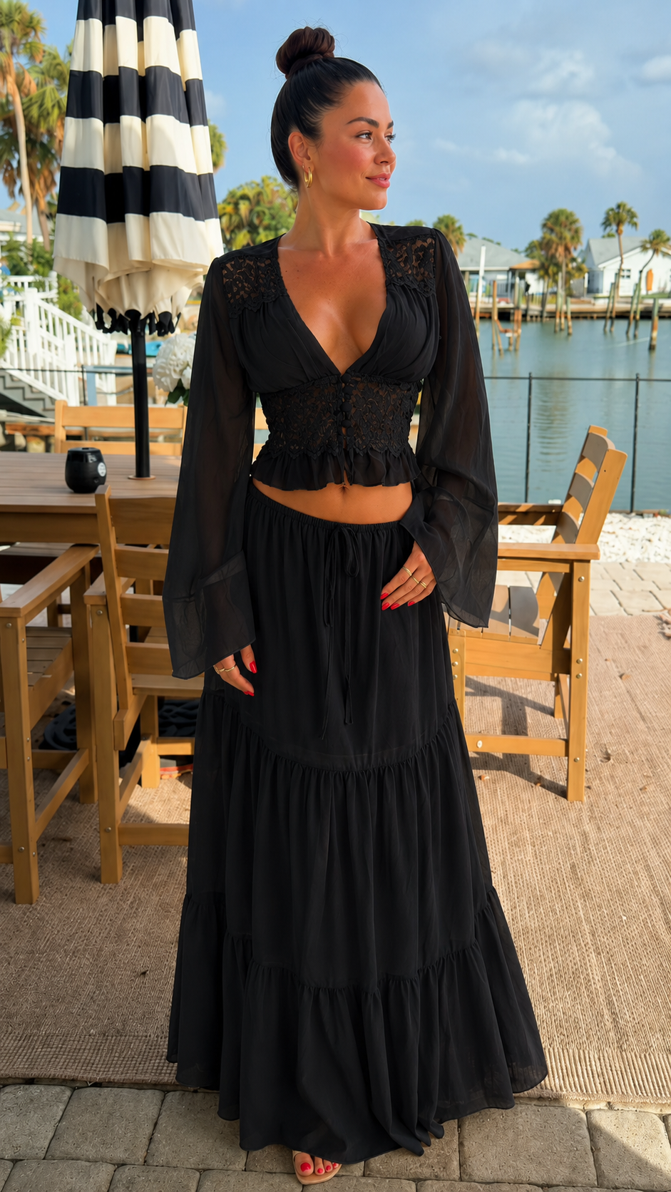 Front view of black sheer sleeve lace crop top and maxi skirt set
