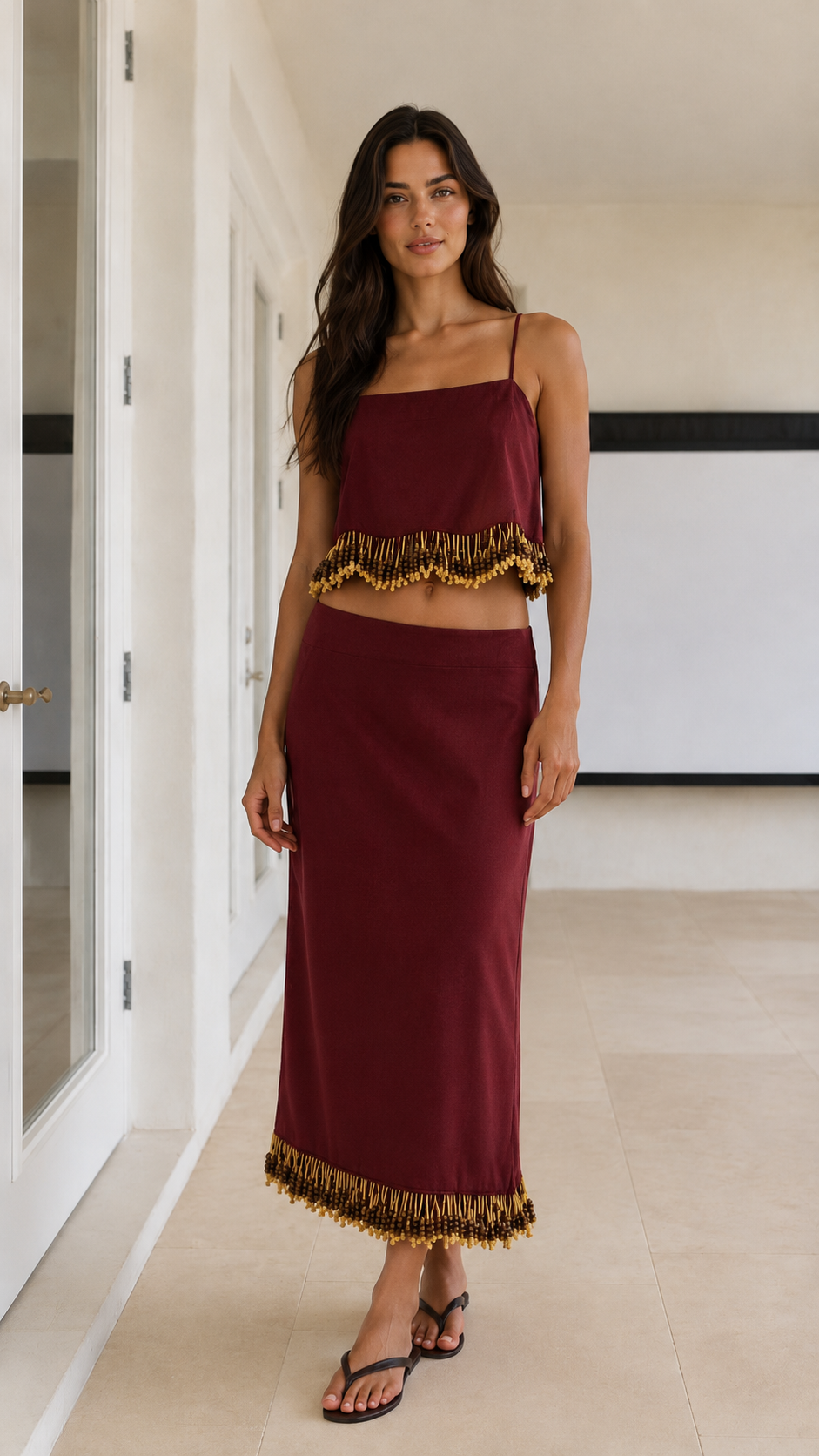 Front view of wine red cami top and maxi skirt matching set with fringe trim